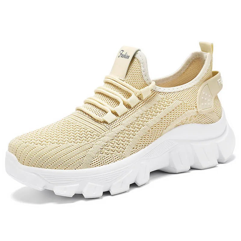 Women's white Flyknit sneakers with a thick PVC sole and front lace-up on a plain background.
