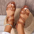 Women's black flat sandals with round toe and adjustable Velcro fastening strap.