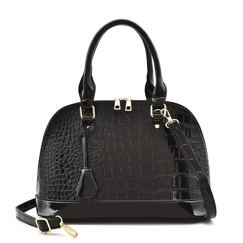 Shiny black PU leather crossbody shoulder bag with a structured shell shape.
