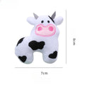 Colourful plush cat toy shaped like a cow, a crocodile, or a parrot on a plain background.