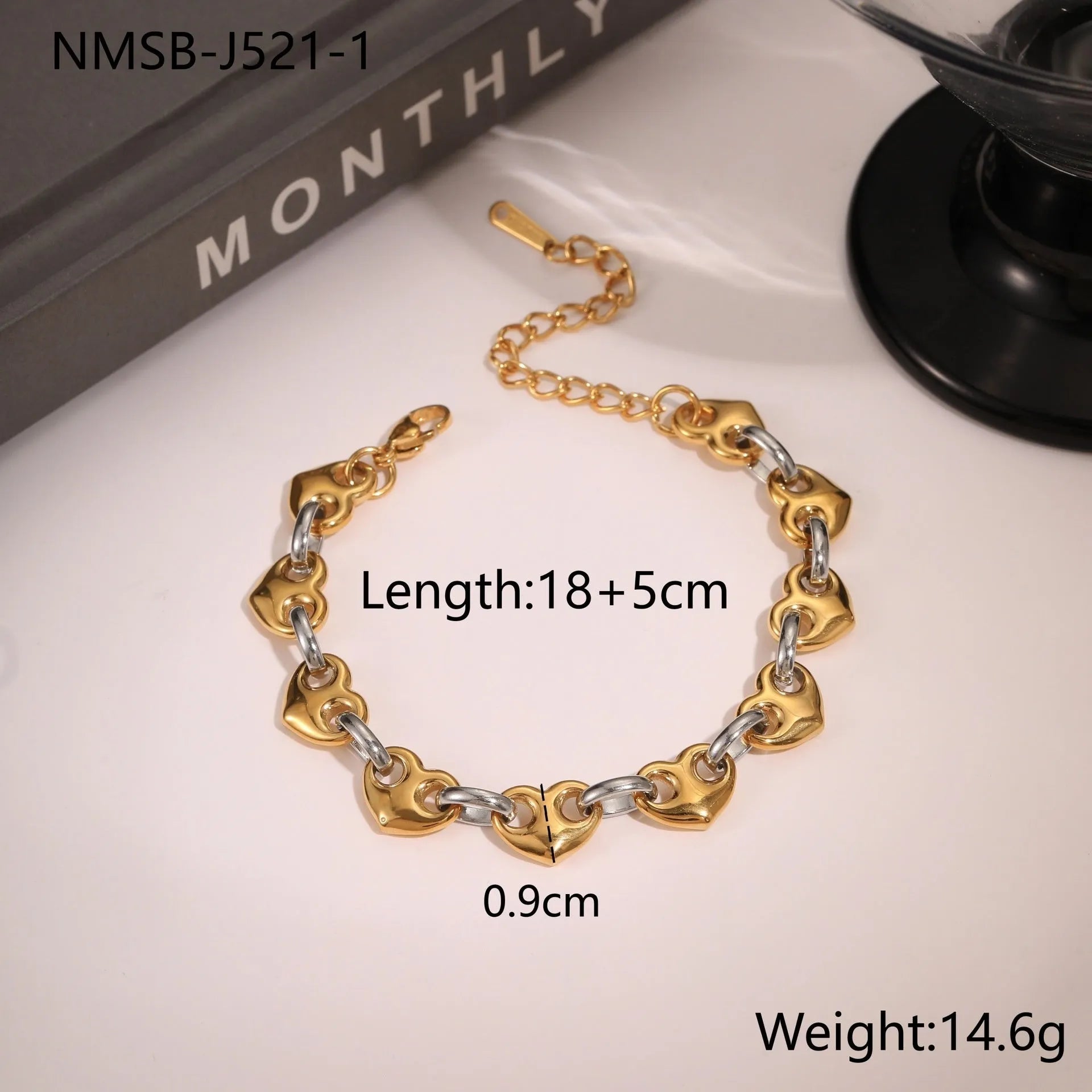 Stainless steel bracelet with a hollowed-out heart charm in a gold electroplated finish.