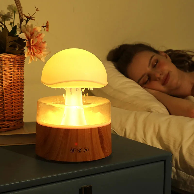 White rain cloud shaped ultrasonic humidifier and aroma diffuser with LED lighting showing rainfall simulation effect