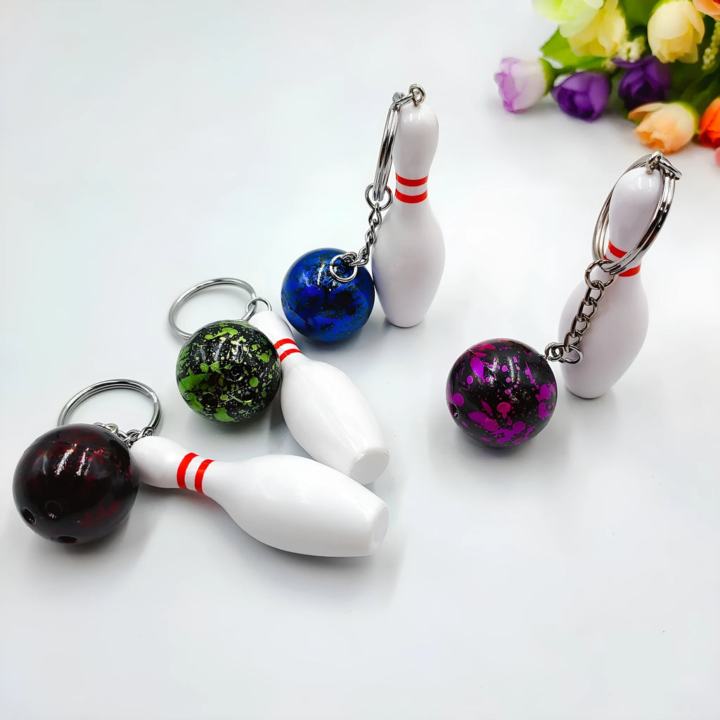 Mini bowling pin simulation keychain pendant in blue, made from PVC and metal on a key ring.