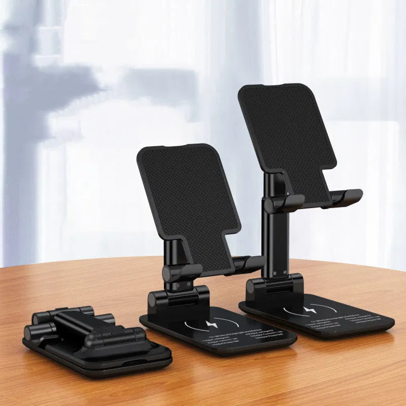 Black wireless charging phone desk stand holding a mobile phone at an angle.