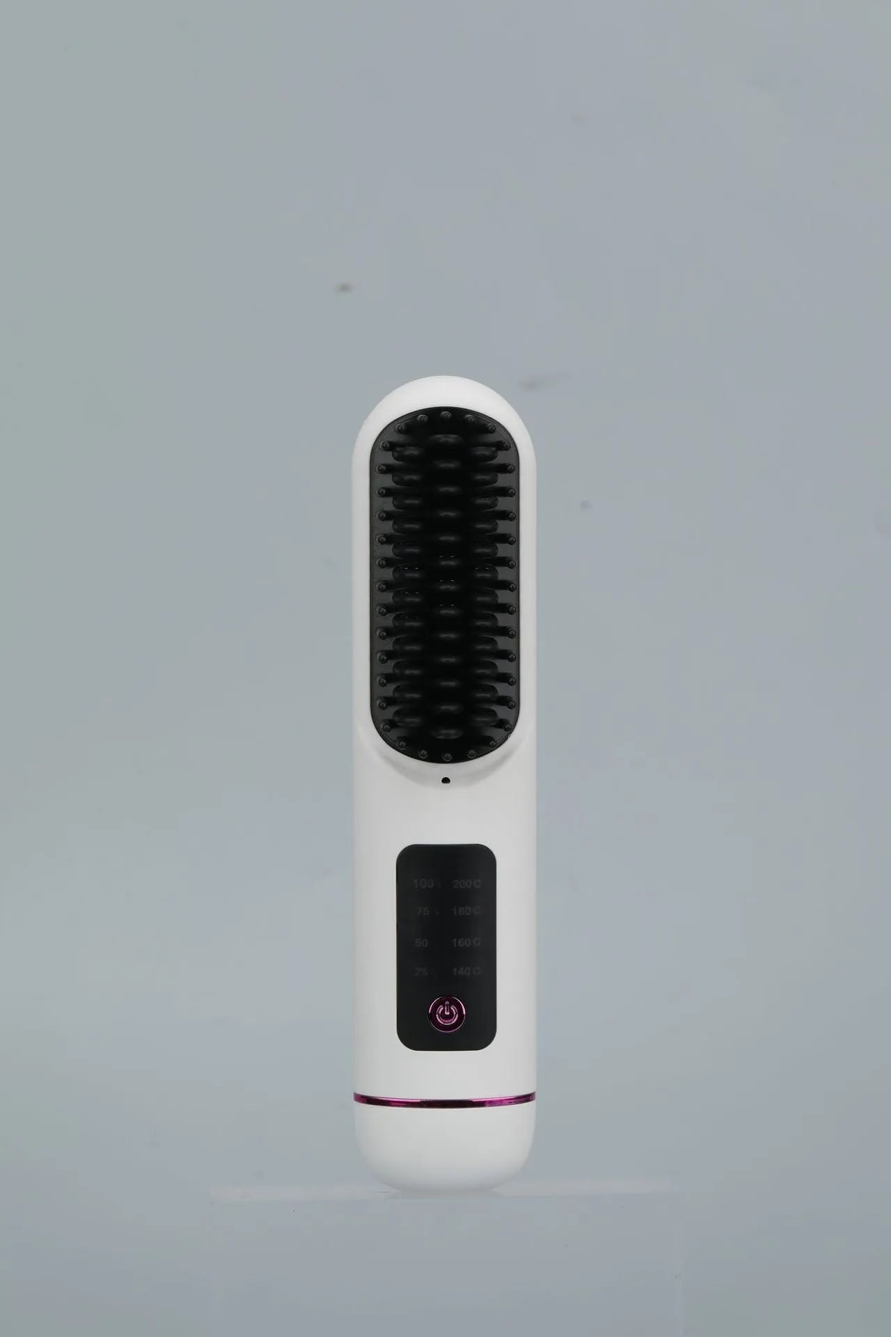 A white portable negative ion hair comb with USB charging port on a dark surface.