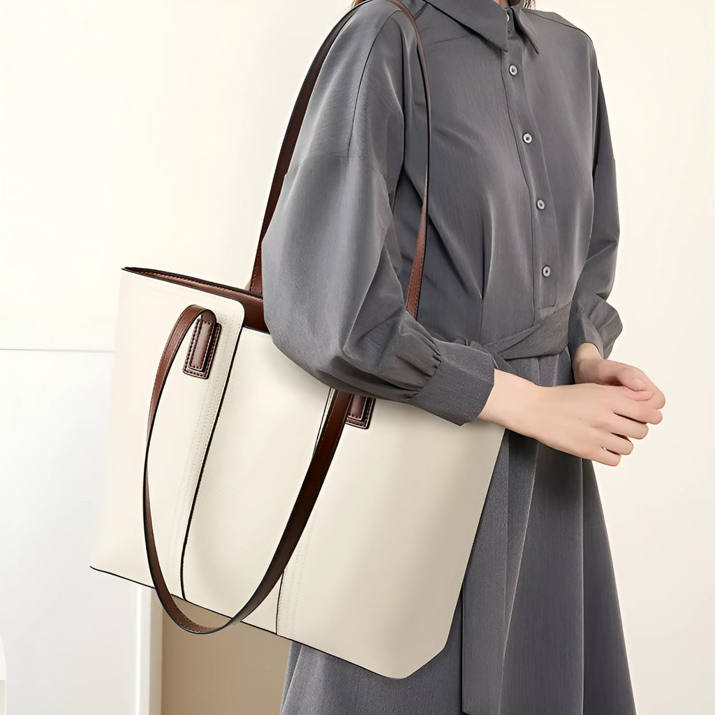 Women's black genuine leather crossbody bag showing internal compartments and horizontal square shape