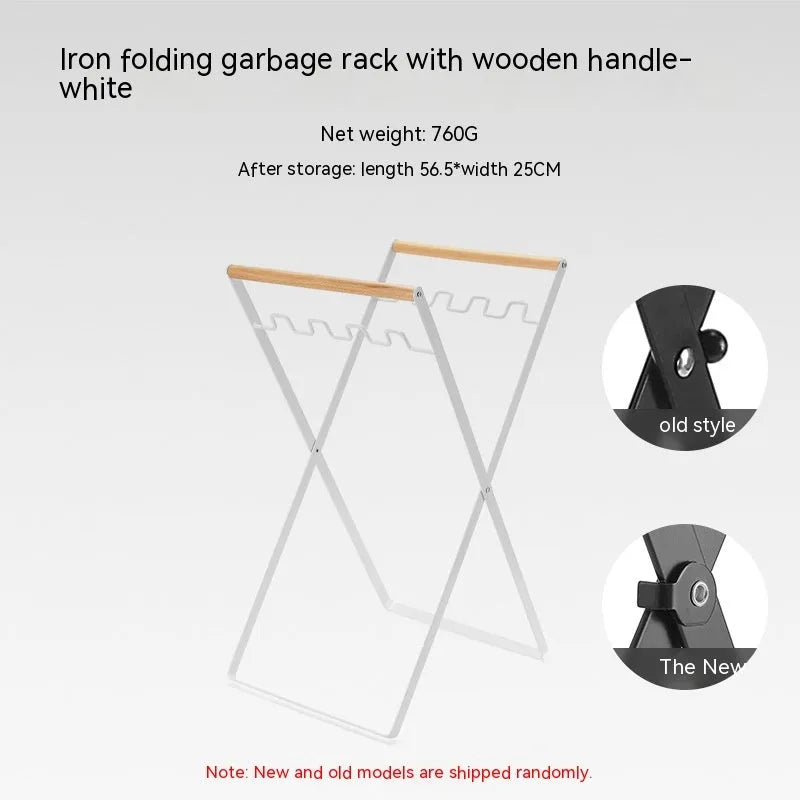 Folding black outdoor trash bag hanger with wooden carry handle on a patio.