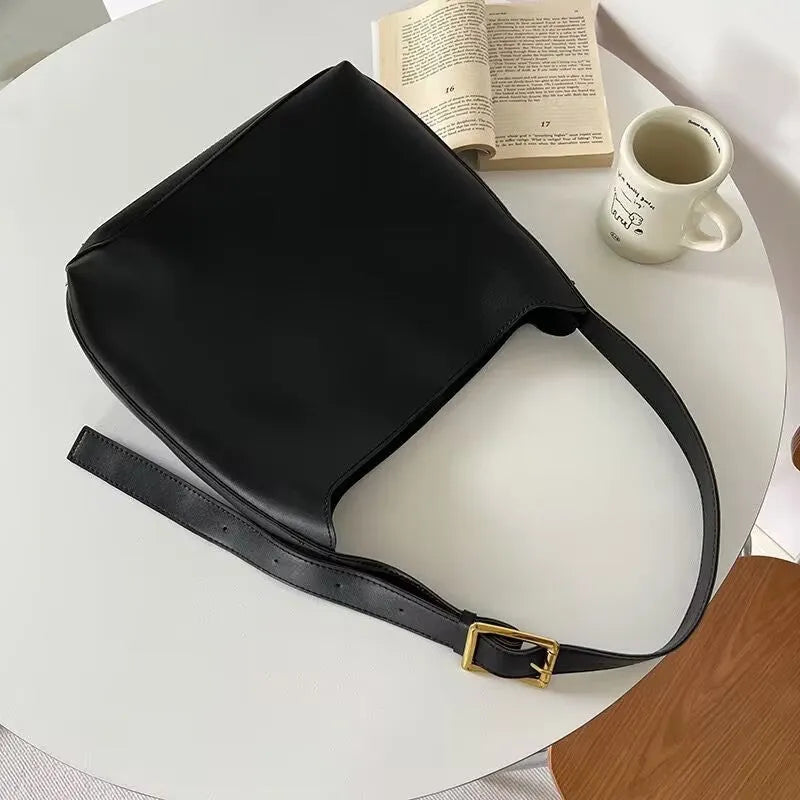 Women's soft PU leather shoulder bag with decorative threads measuring 28x32x12cm in black and brown colour options