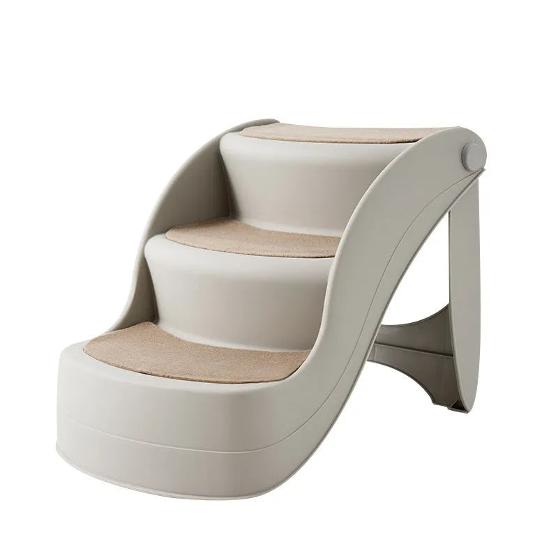 Foldable plastic pet step ladder in beige colour with non-slip mat, placed next to a sofa.