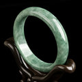 A simple natural emerald green jade bracelet for women, presented with a certificate and gift box.