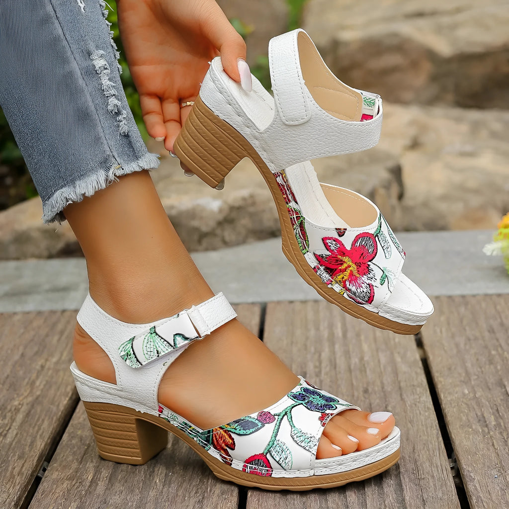 White women's high heel sandals with a Velcro buckle strap and a rubber sole.