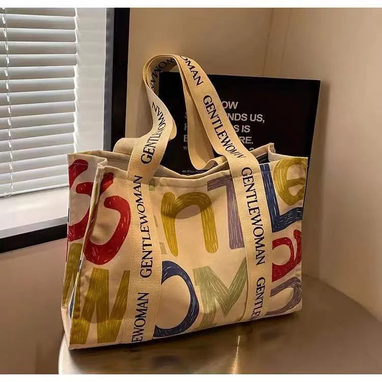 Large canvas women's tote bag with printed design, shown in available colour and pattern options