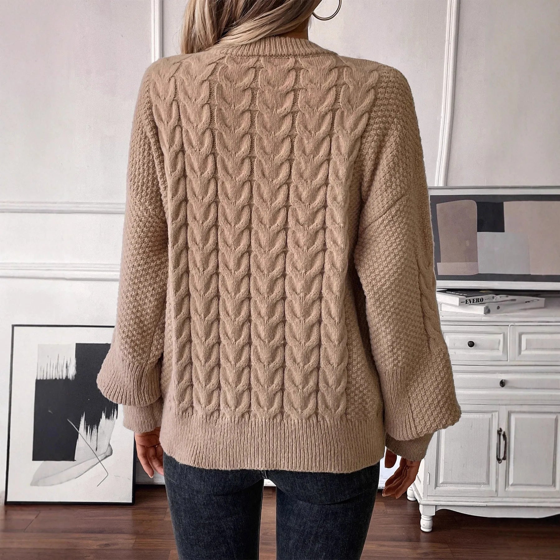 Women's beige loose-fit round neck casual pullover sweater on a hanger.