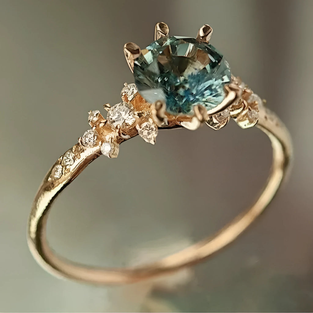 Gold plated geometric ring with claw setting holding zircon stones, showing chamfered square pattern detail