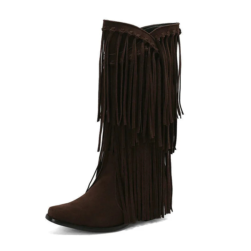 Women's beige suede mid-calf boots with a chunky heel and tassel detail on display.
