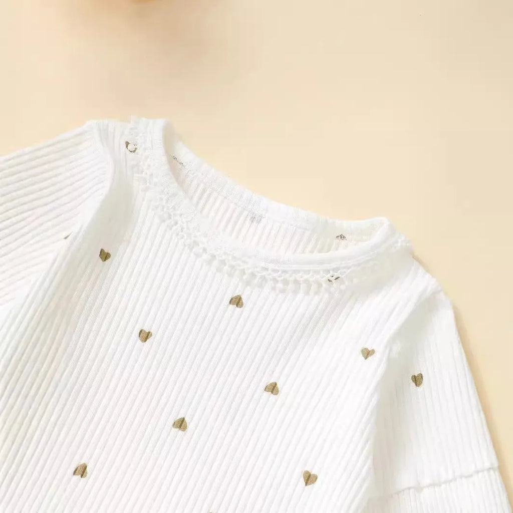 White cotton baby suit three-piece set with top, long pants, and hair tie showing sunken stripe stitching