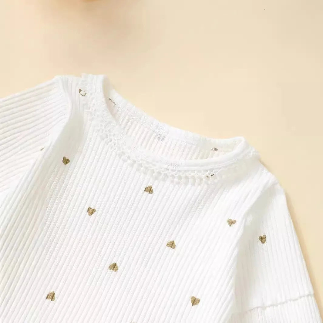 White cotton baby suit three-piece set with top, long pants, and hair tie showing sunken stripe stitching