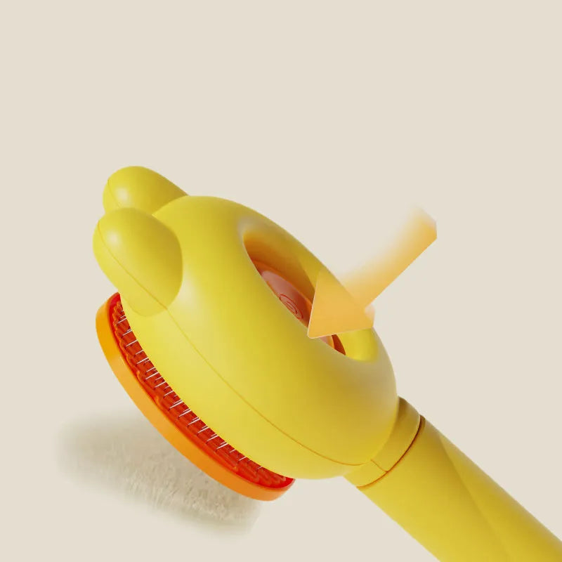 Self-cleaning pet grooming brush with green handle and stainless steel comb, showing the one-click release button.