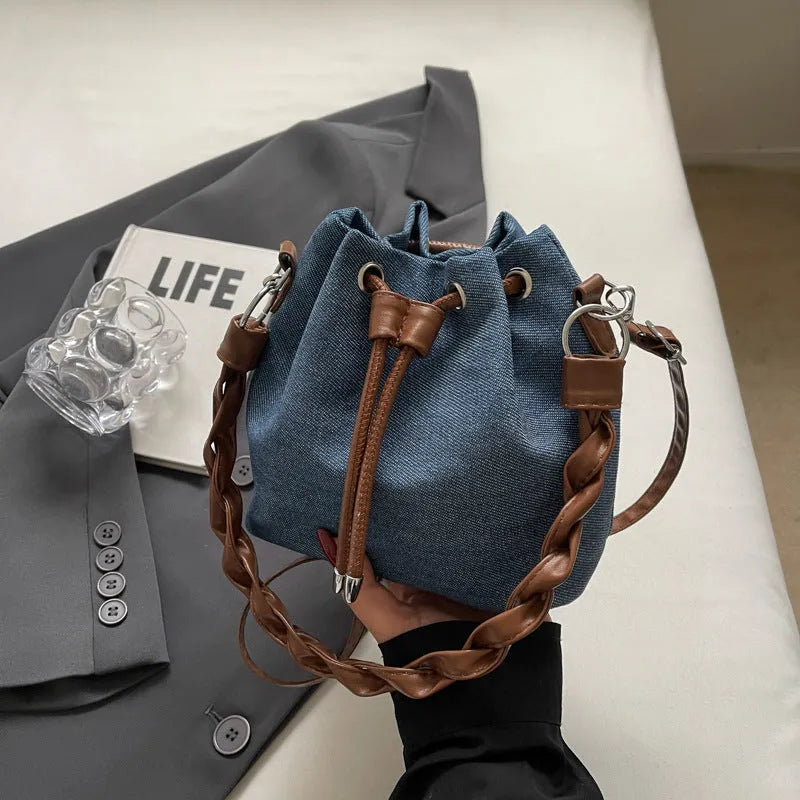 Blue cross body bucket messenger bag with synthetic leather construction