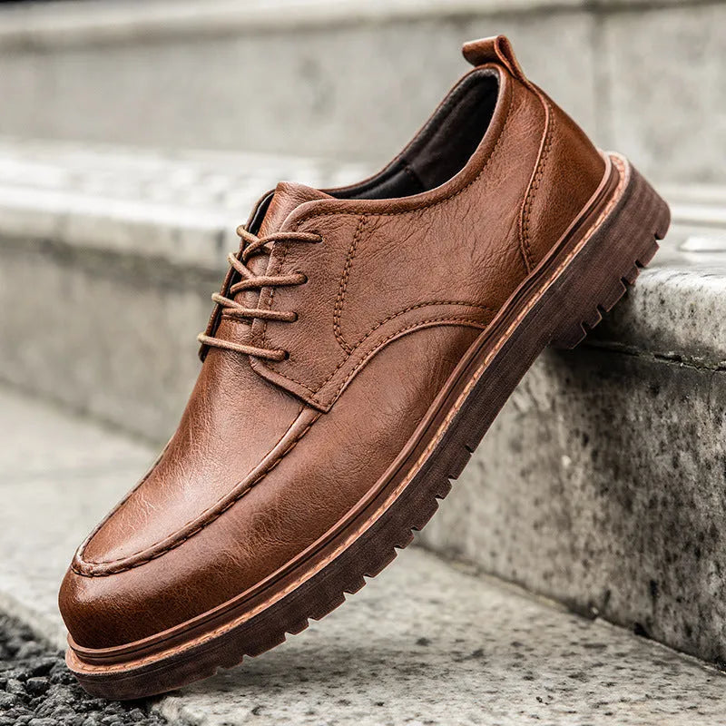 Men's black and brown casual leather shoes with round toe and flat rubber sole.
