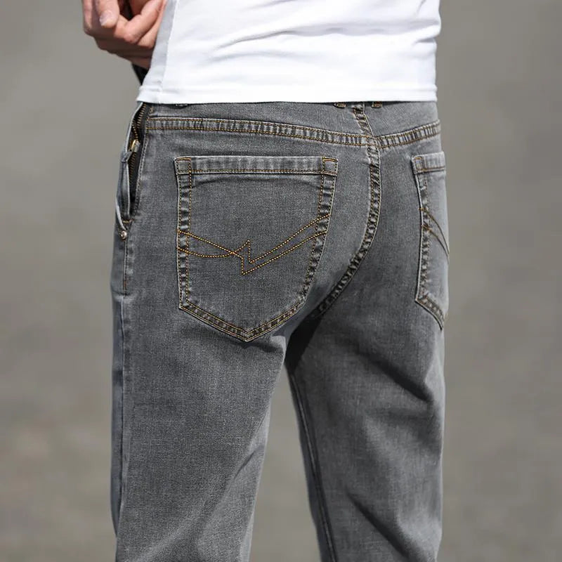 Men's smoky grey autumn jeans with straight tube fit and low waist design on hanger
