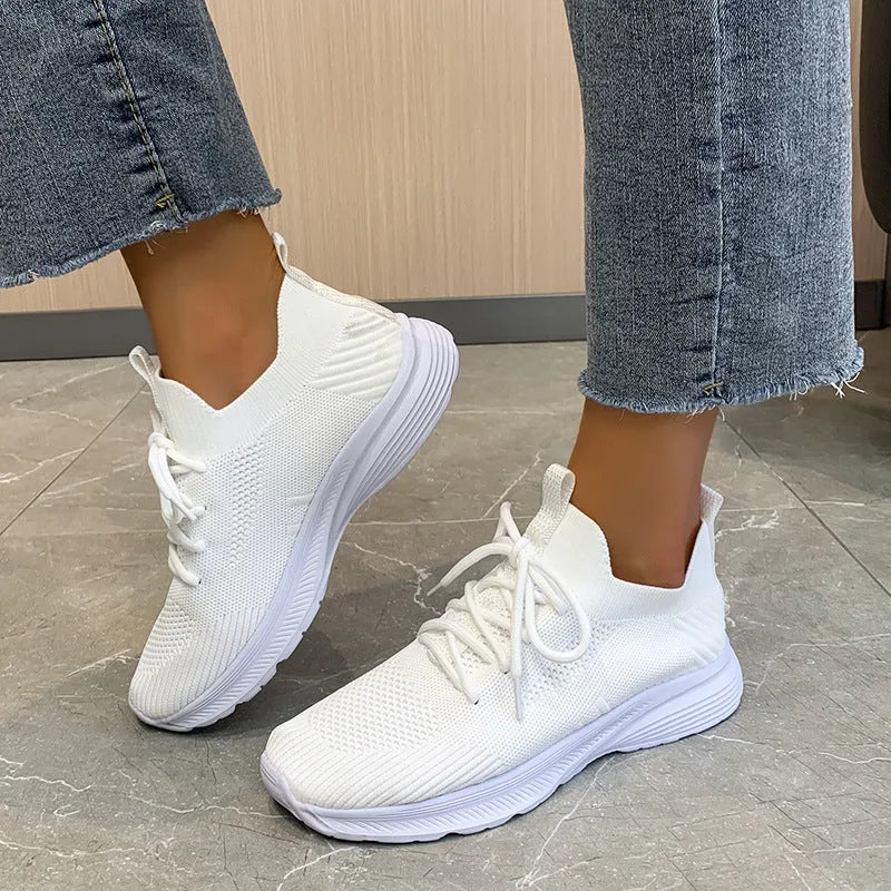 Women's mesh running shoes in Creamy White colour with Flyknit upper and rubber sole
