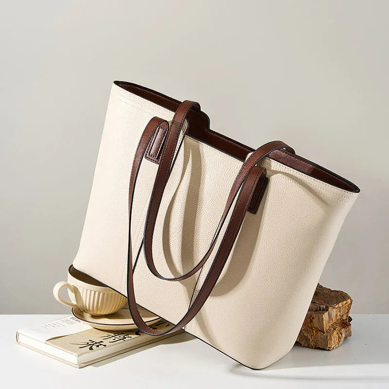 Women's black genuine leather crossbody bag showing internal compartments and horizontal square shape