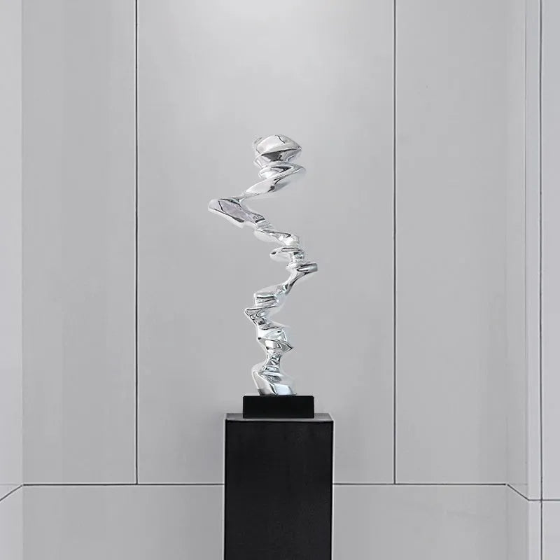 Modern abstract decorative ornament made from natural resin in a choice of gold, silver, or blue.