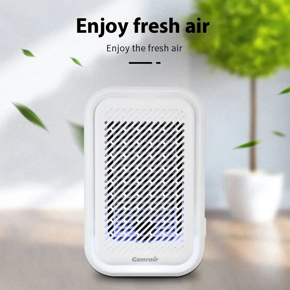 White wall-mounted plug-in air purifier with filter screen for small rooms.