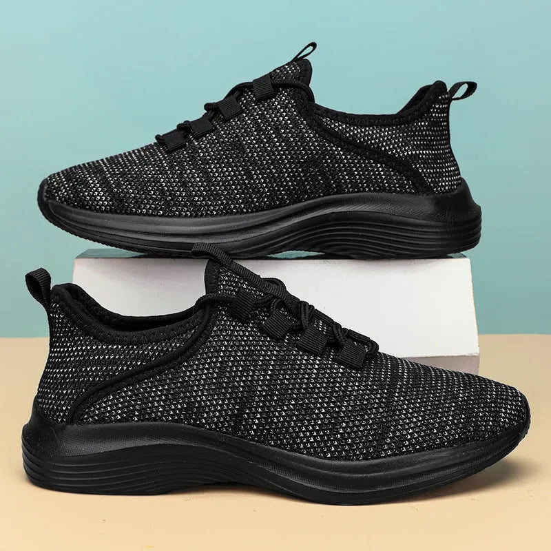 Women's low-top Flyknit mesh sneaker in black with round toe and lace-up front.