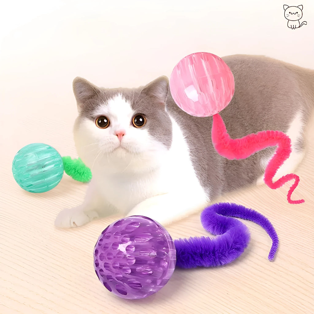 Interactive cat toy with purple bouncy ball and plush tail on wooden floor