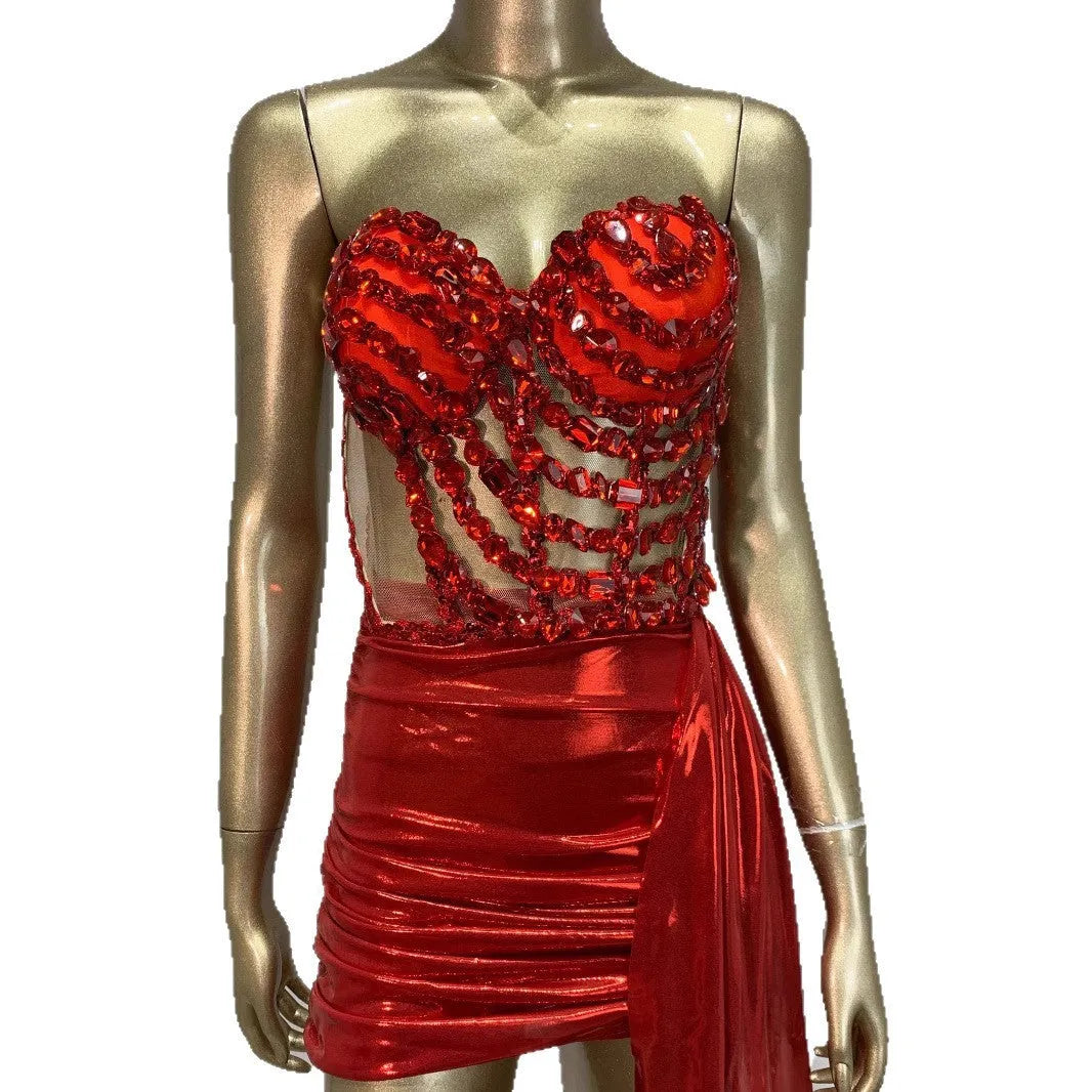 Red women's skirt suit with see-through mesh panels, made from stretch spandex fabric.