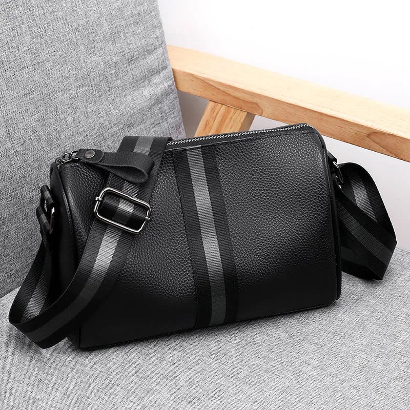 Black genuine leather one-shoulder crossbody bag showing its large capacity and crossbody strap.