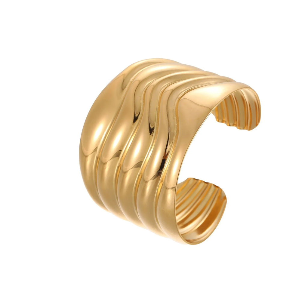Women's wide cuff bracelet with gold plating and exaggerated niche opening in asymmetric wave design