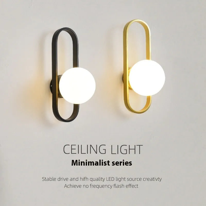Minimalist wall lamp with glass shade and iron body in black or gold finish