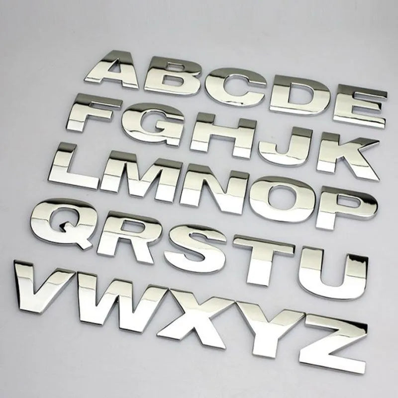3D metal zinc alloy car letter sticker showing raised silver letter on clear adhesive backing.