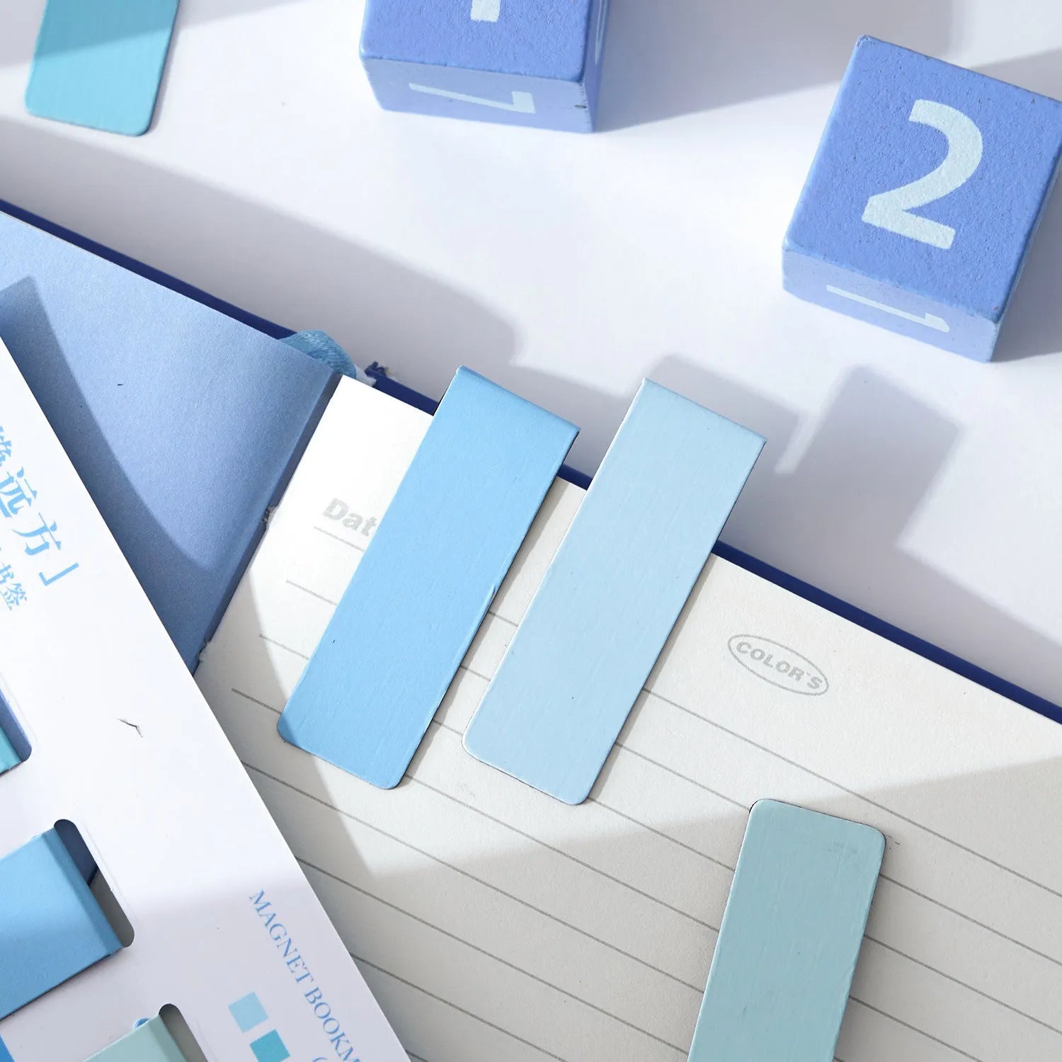Set of four Morandi Series pastel colour-block magnetic bookmarks on a book page.