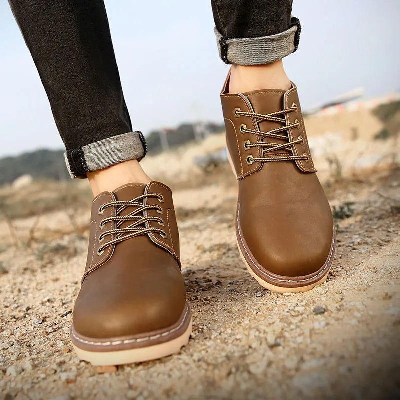 Men's black mid-top waterproof PU leather boots with a flat rubber sole.
