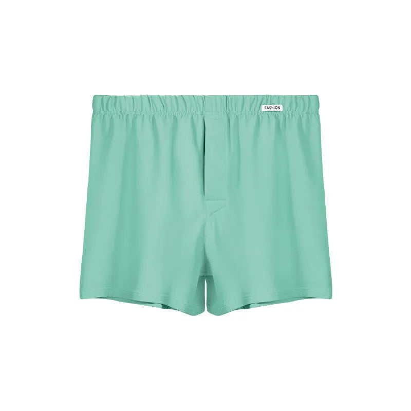 Men's loose-fitting cotton boxer shorts in solid colours like gold and green.
