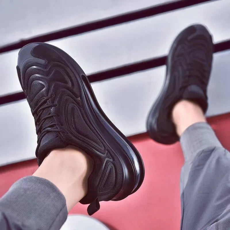 Men's black thick sole lace-up sneakers with a round toe and low-cut design.