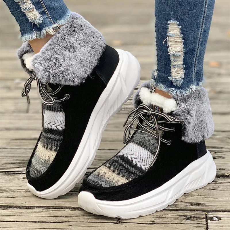 Women's beige lace-up snow boots with suede upper, thick rubber sole, and decorative stitching