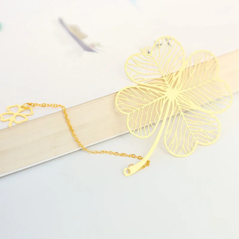 Brass metal bookmark with hollow leaf pattern design and rose gold tassel