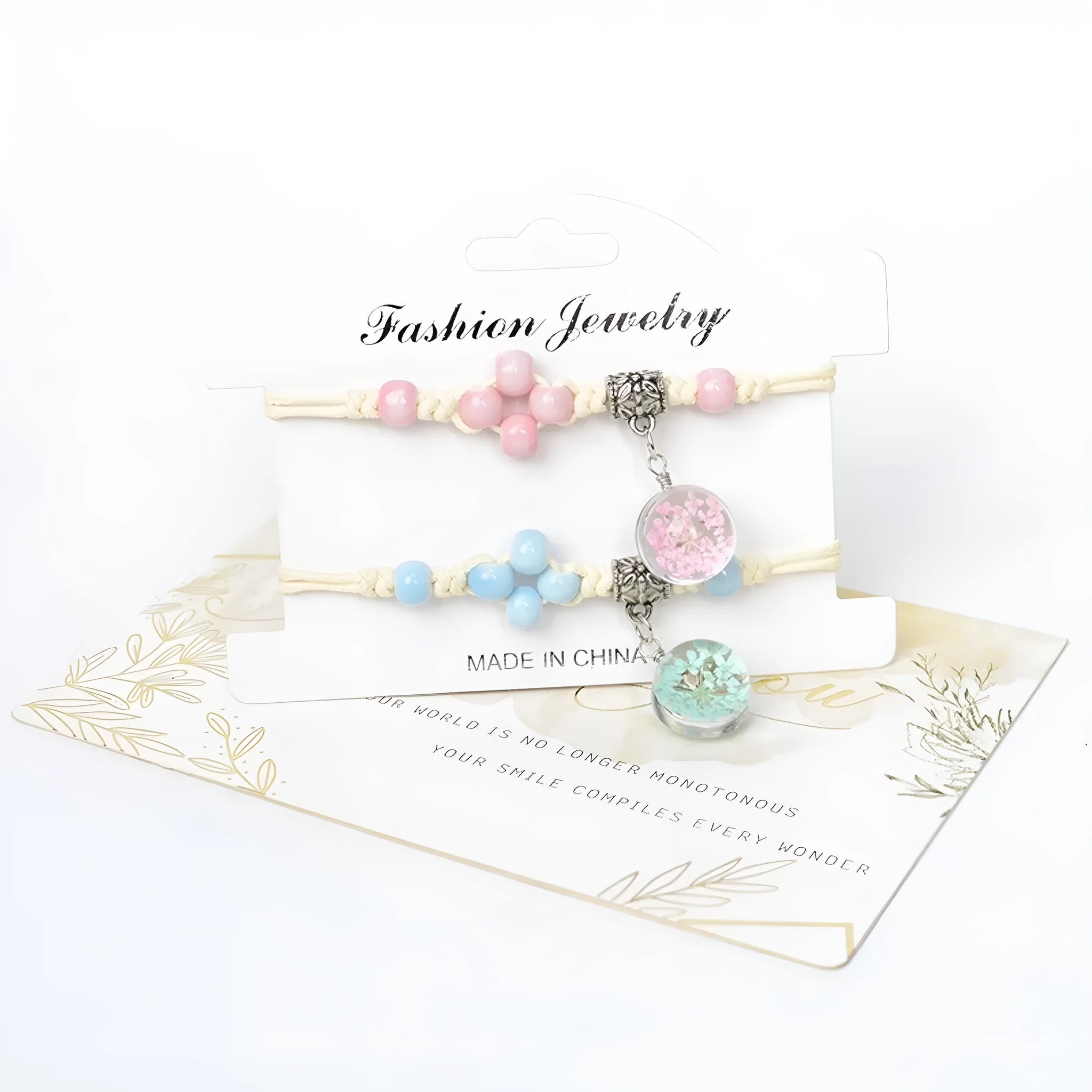 Glass bracelet with large colourful beads containing real dried flowers, on a white background.