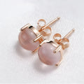 Rose gold drop shape stud earrings with synthetic ross quartz crystal inlay.