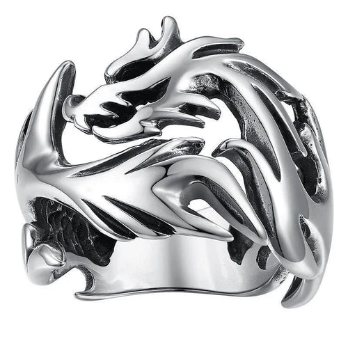 Close-up of an adjustable silver blue and green metal ring with a Chinese dragon pattern.
