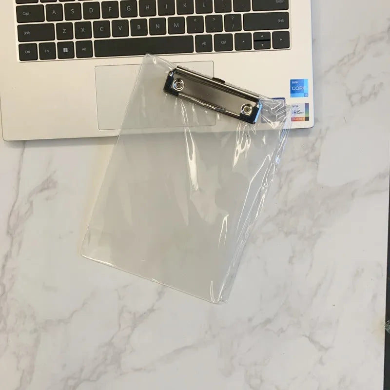 Transparent A4 plastic writing board pad with a silver metal clip, shown in blue colour.