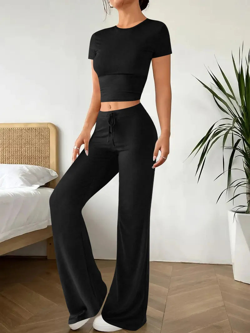 Black high waist trousers and short sleeve t-shirt women's co-ord set on a hanger.