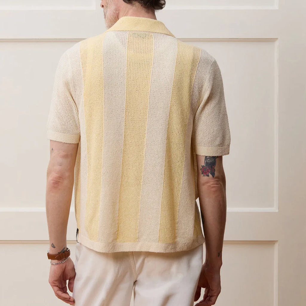 Yellow short-sleeved polo shirt with hollow-out asymmetric design detail on Tencel fabric