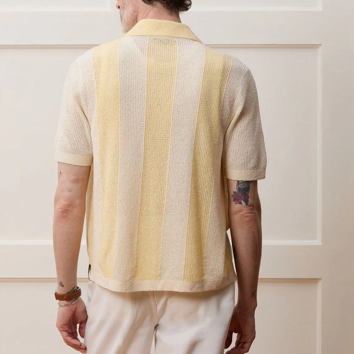 Yellow short-sleeved polo shirt with hollow-out asymmetric design detail on Tencel fabric