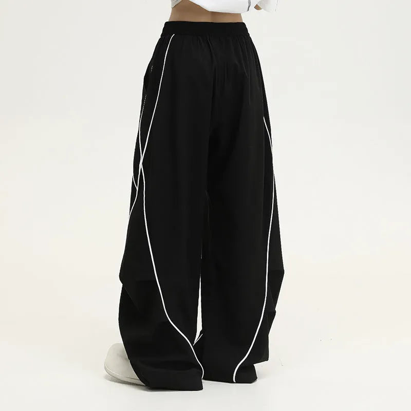 Black and white striped pleated wide-leg hip hop pants on a neutral background